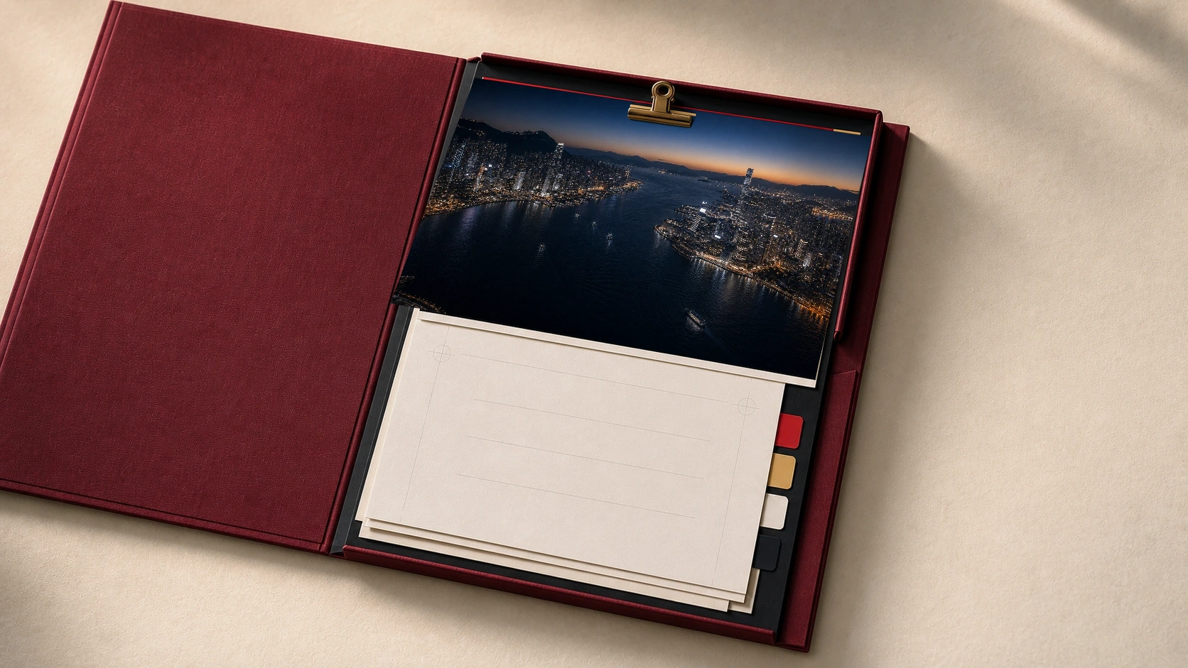 An open dossier folder holding a clipped photograph of Hong Kong Harbour at dusk